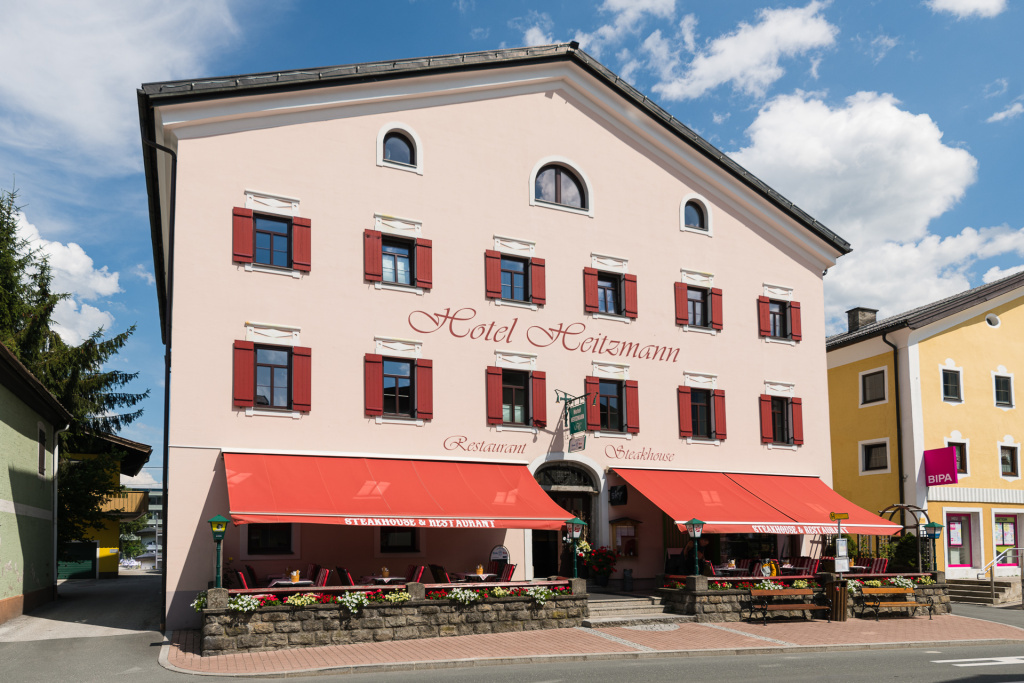 Hotel Mittersill with Red Awning and Outdoor Terrace in Salzburger Land